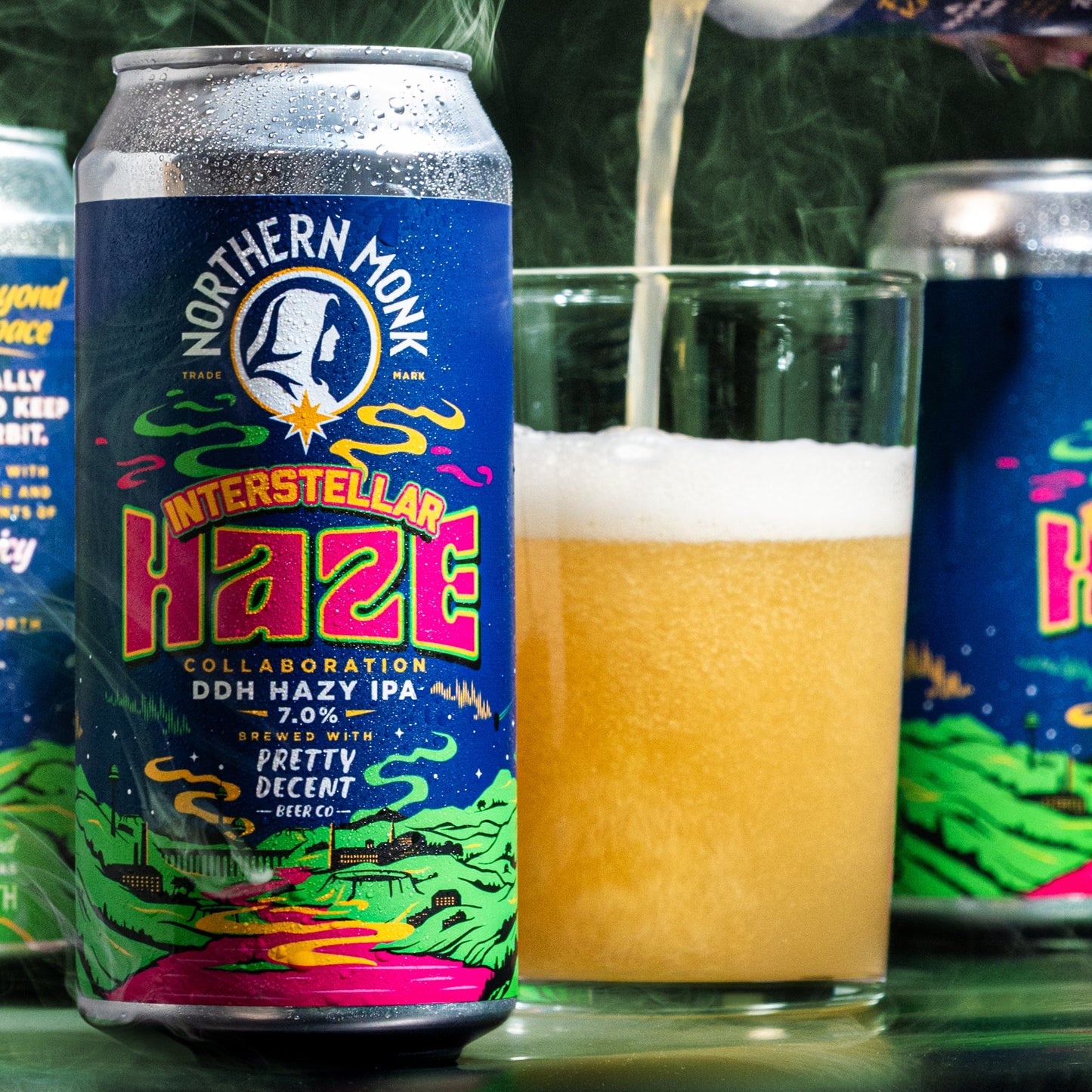 Can of Northern Monk Interstellar
Haze IPA being poured into a glass with a green leafy background.