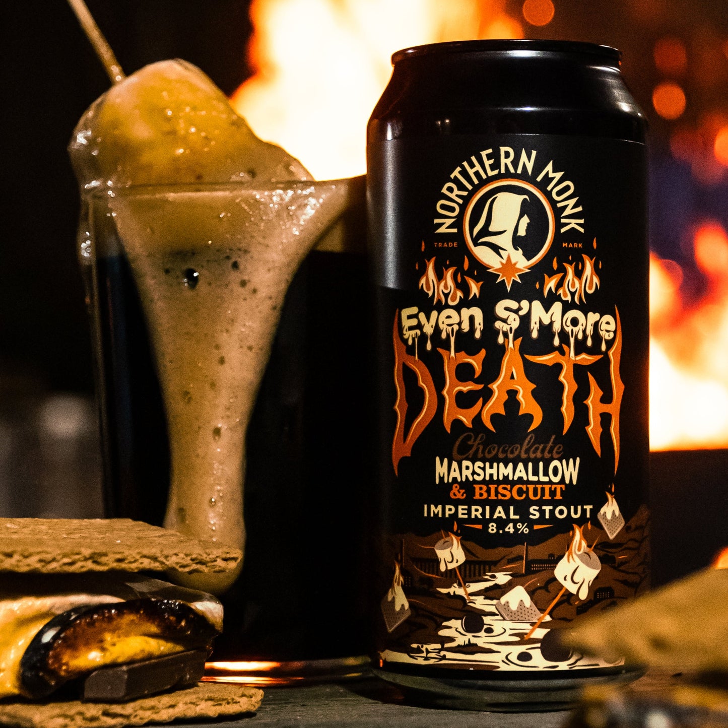 Can of Northern Monk 'Even S'More Death' Imperial Stout with marshmallow on a stick in front of a fire.